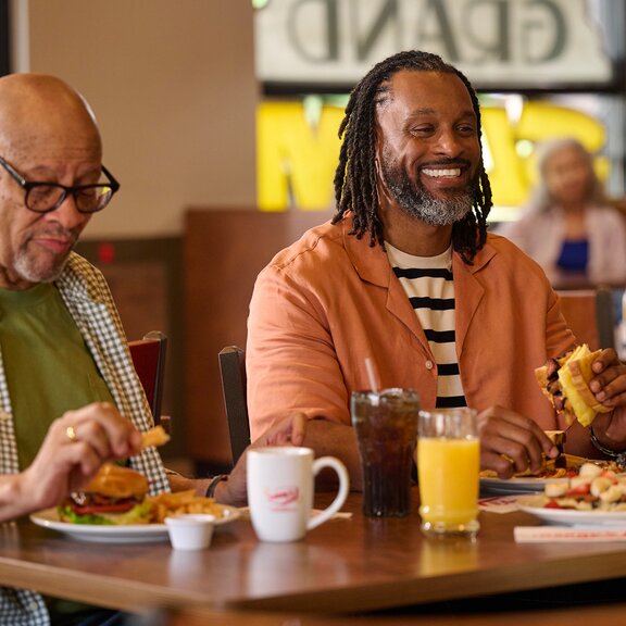 Two men eating at Denny's