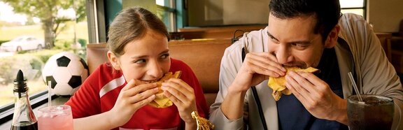 Father and Daughter Eating at Denny's