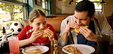 Father and Daughter Eating at Denny's